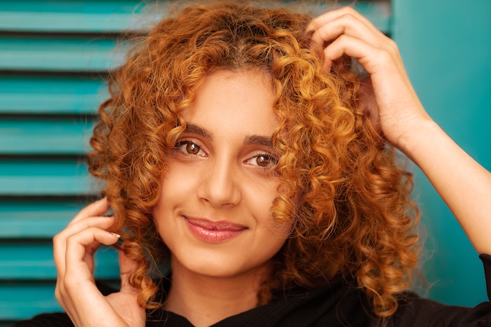 portrait of a woman with ginger curly hair