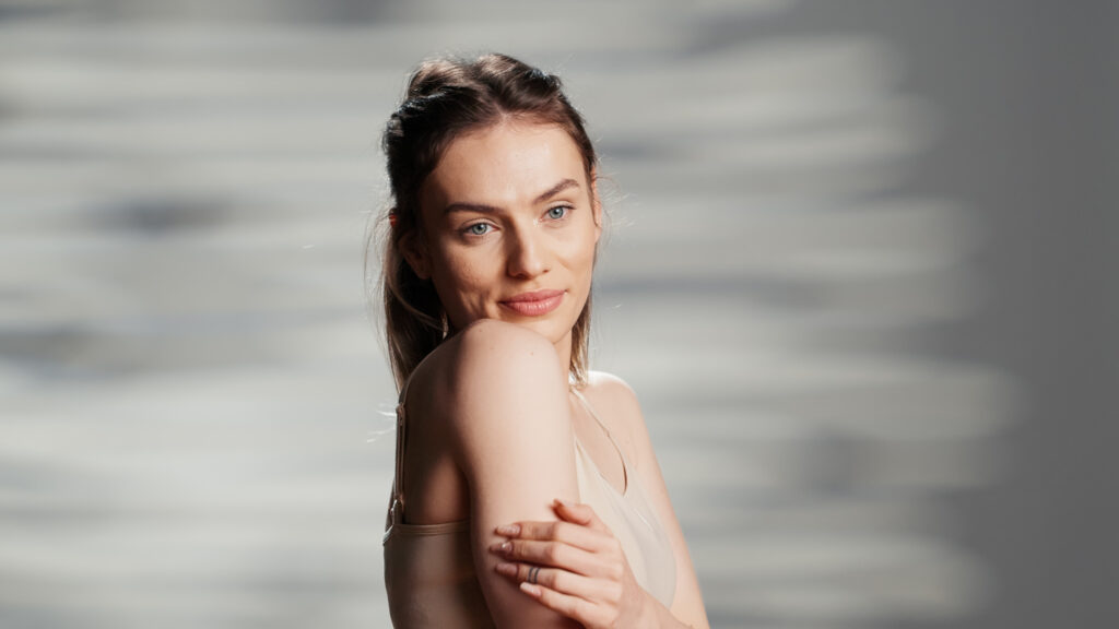 Woman with glowing skin after HIFU treatment, showcasing non-surgical face and body rejuvenation results